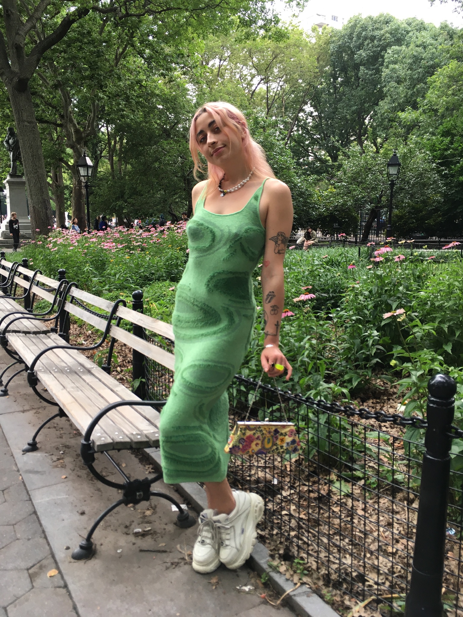 Person standing in park wearing House of Sunny green dress styled with white Buffalo London platform sneakers