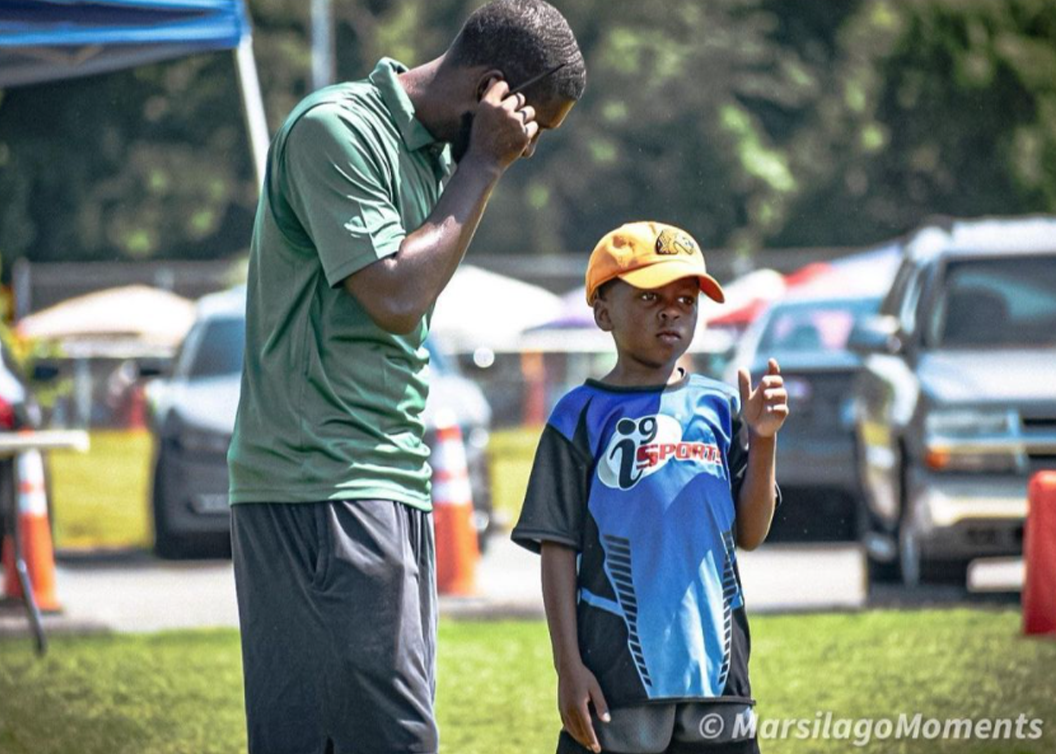 Child and adult standing in front of parking lot during Lessons for Life event