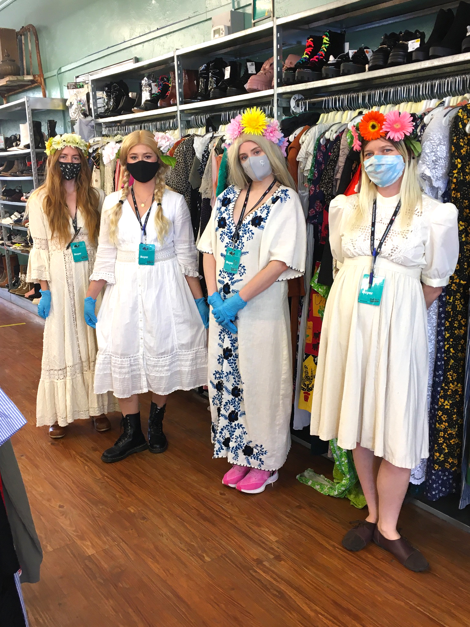 4 Women standing in front of a clothing rack wearing Midsommar costumes