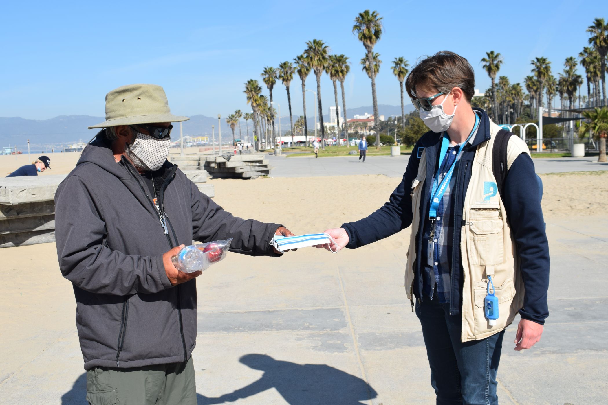 a volunteer handing supplies to a person