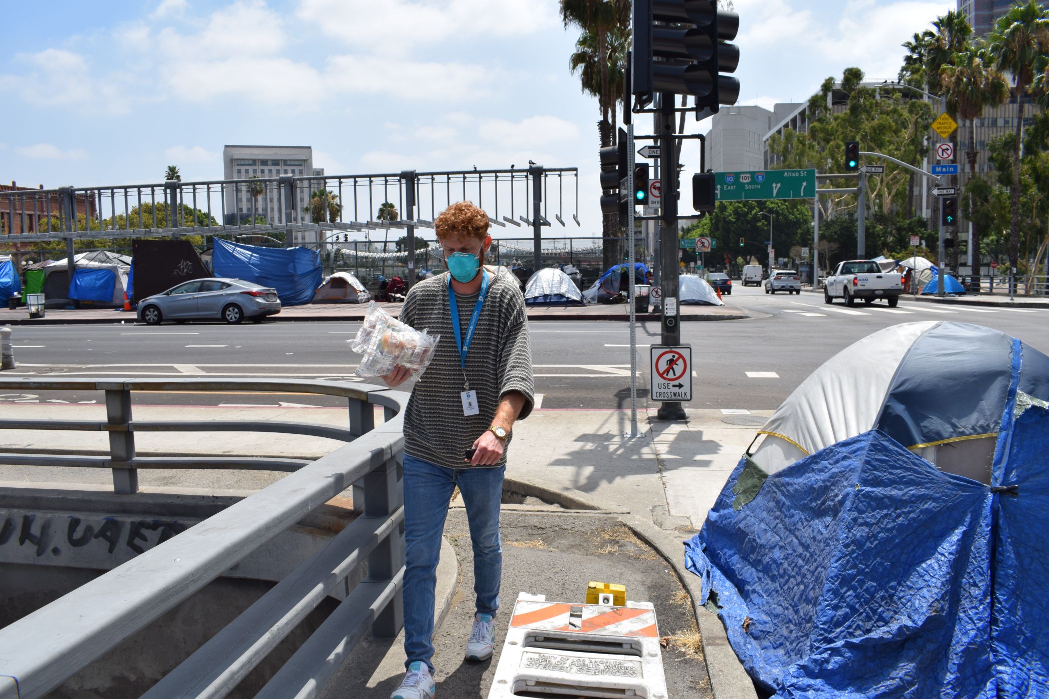 A volunteer bringing supplies to a homeless camp site