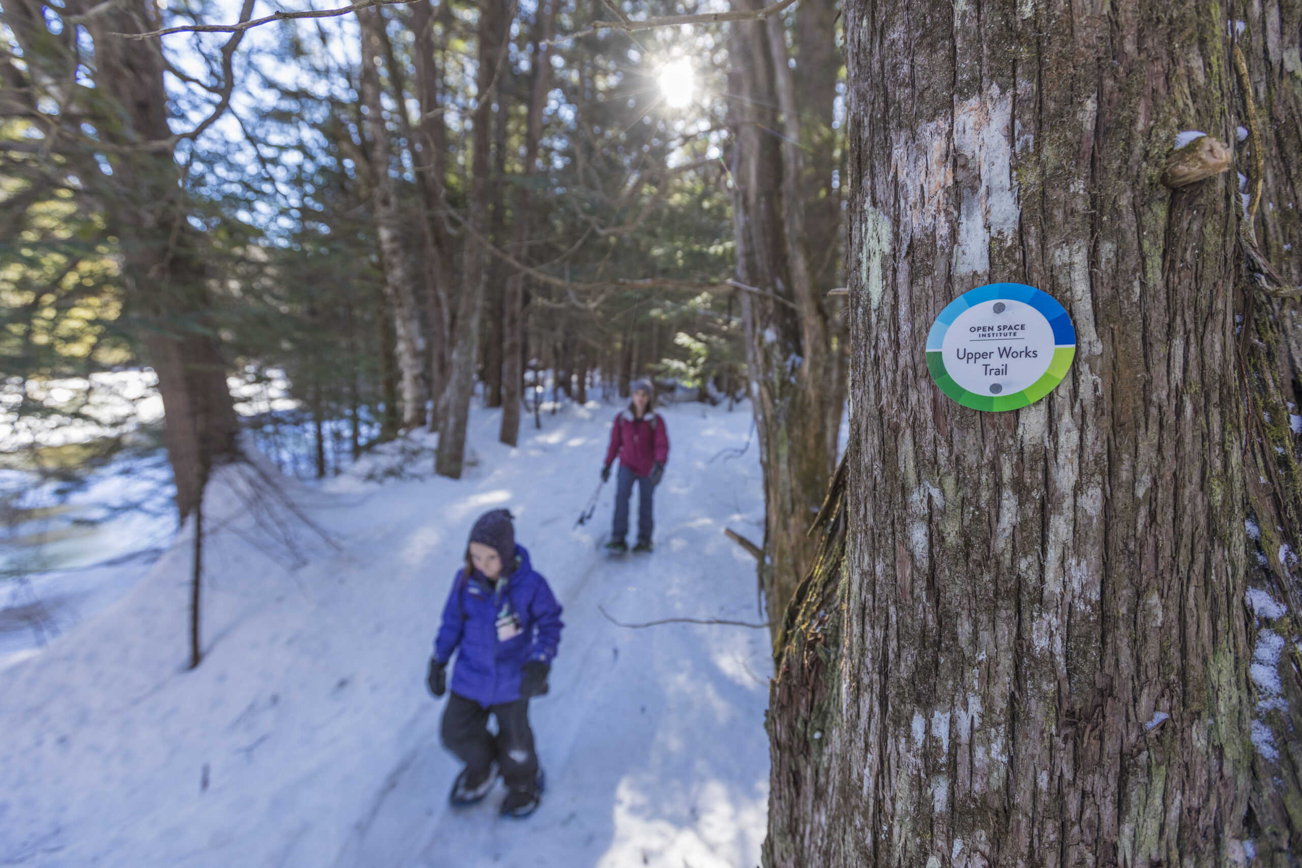 Two children hiking in the snow