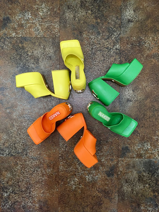 Three pairs of 70's inspired platform heels in neon citrus colors