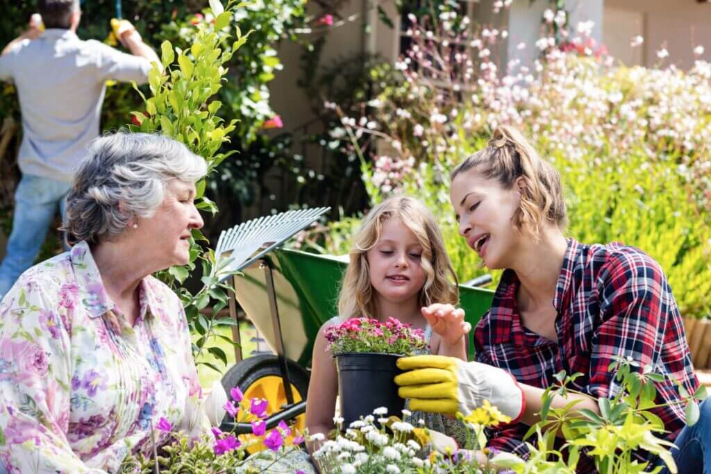 Grandmother, mother and daughter gardening together