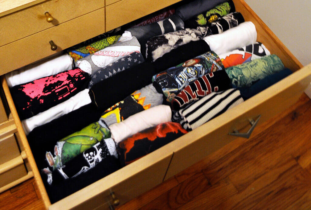 T-shirts folded up and inside a drawer