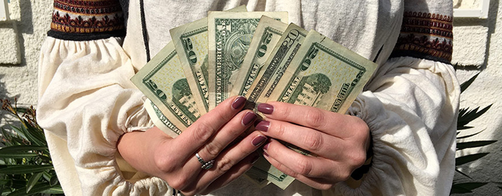 Persons hands holding cash