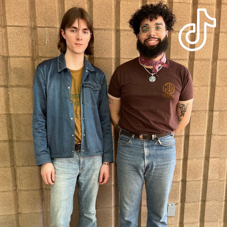 Two people wearing denim clothing looking at the camera