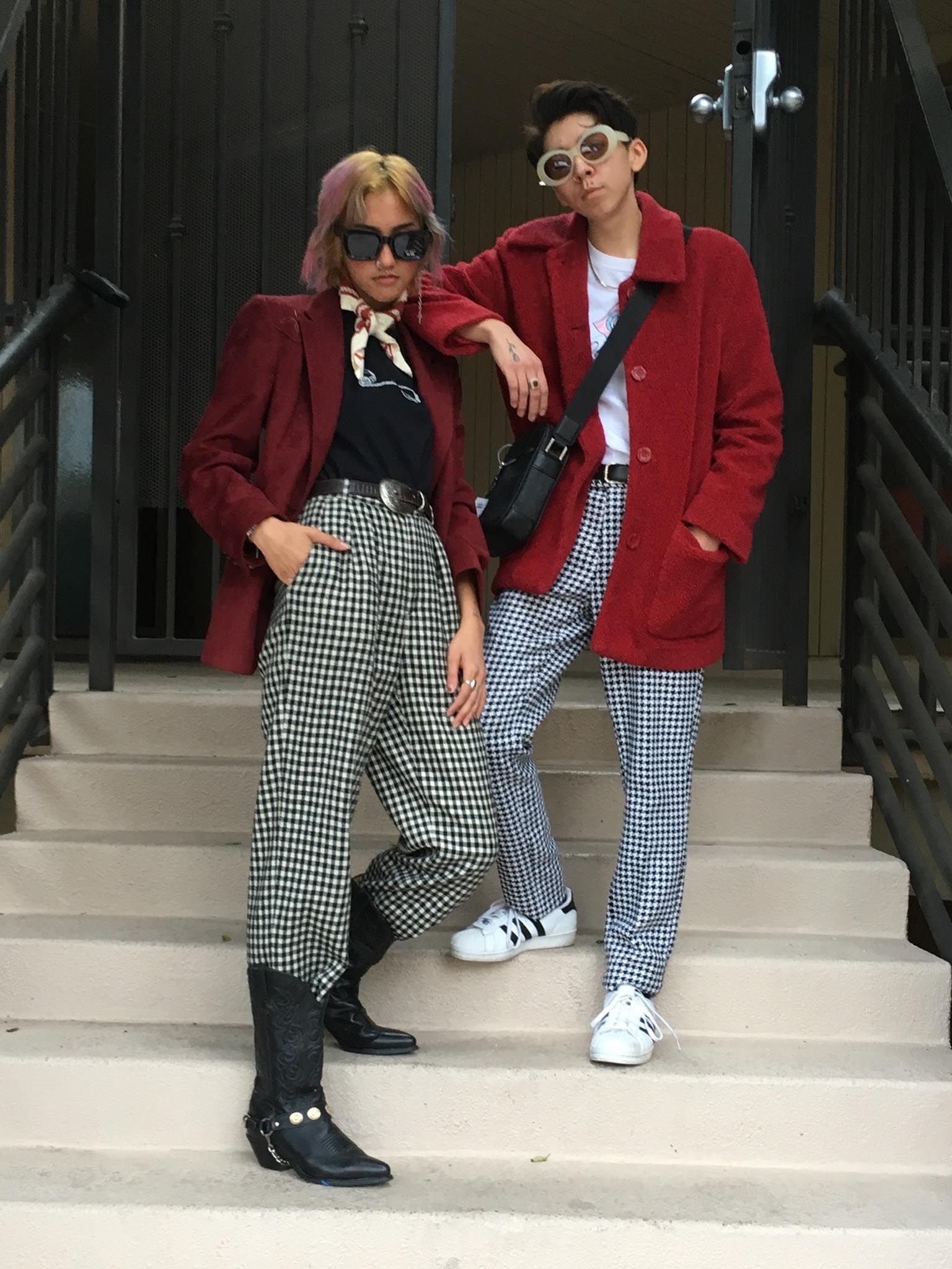Two people wearing red jackets and black and white gingham pants