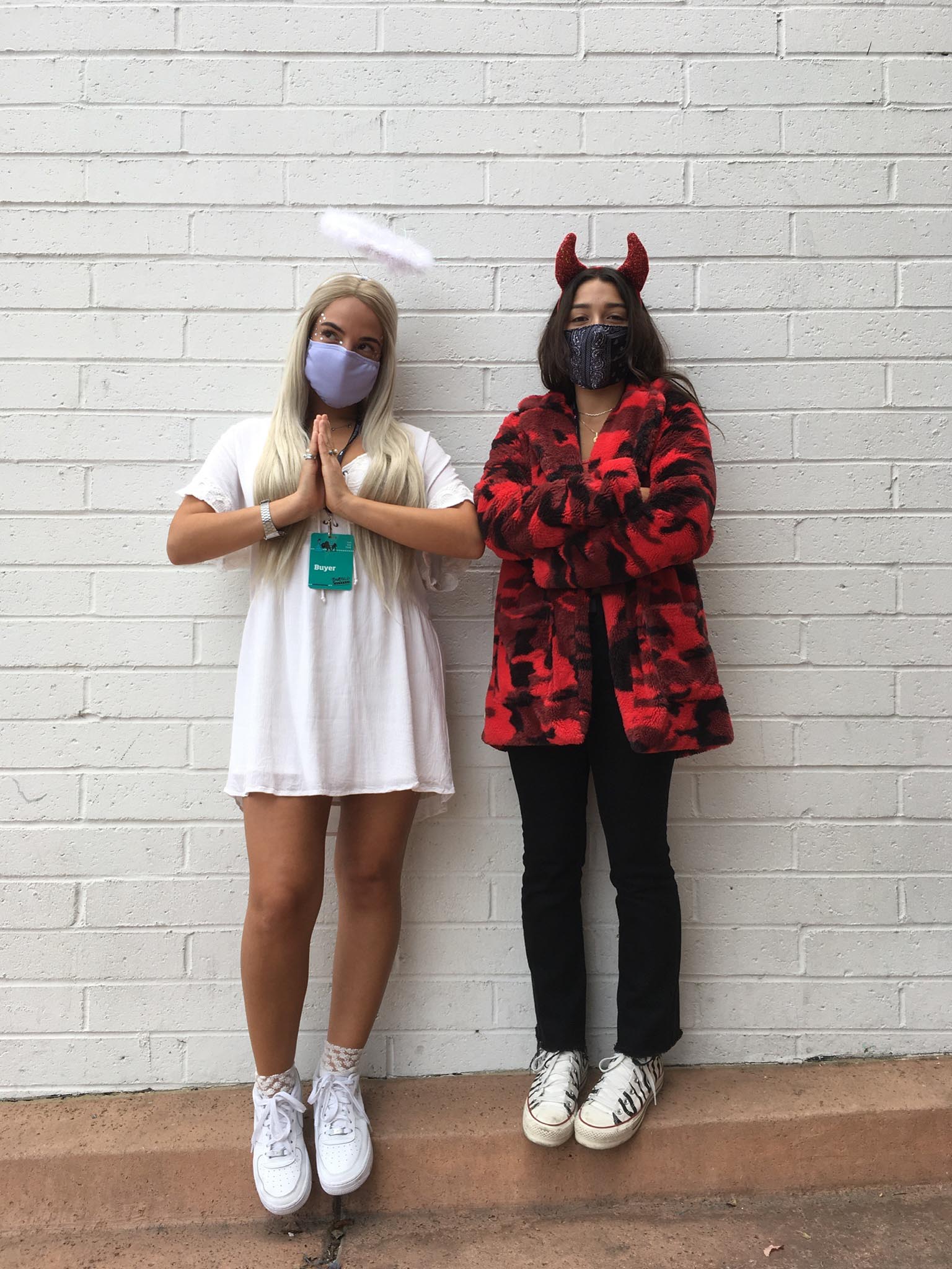 2 People Wearing Angel Costume of white mini dress and halo and devil costume of red camo faux fur coat and horns