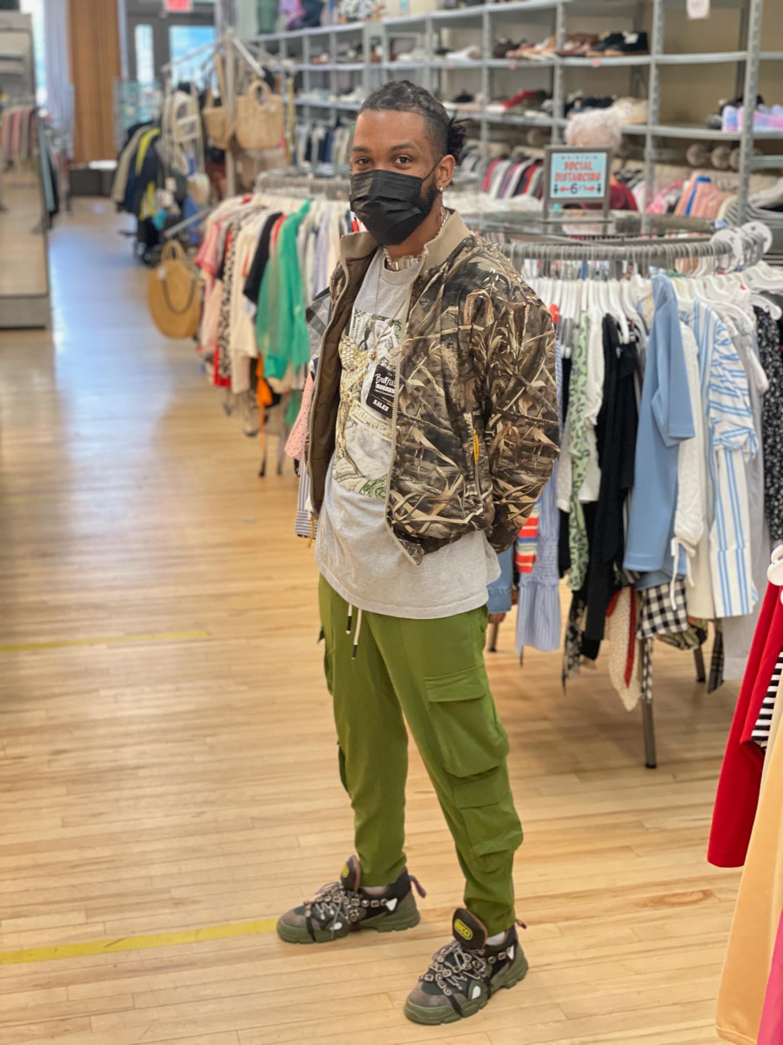 Gucci sneakers styled with olive cargo pants and camo jacket