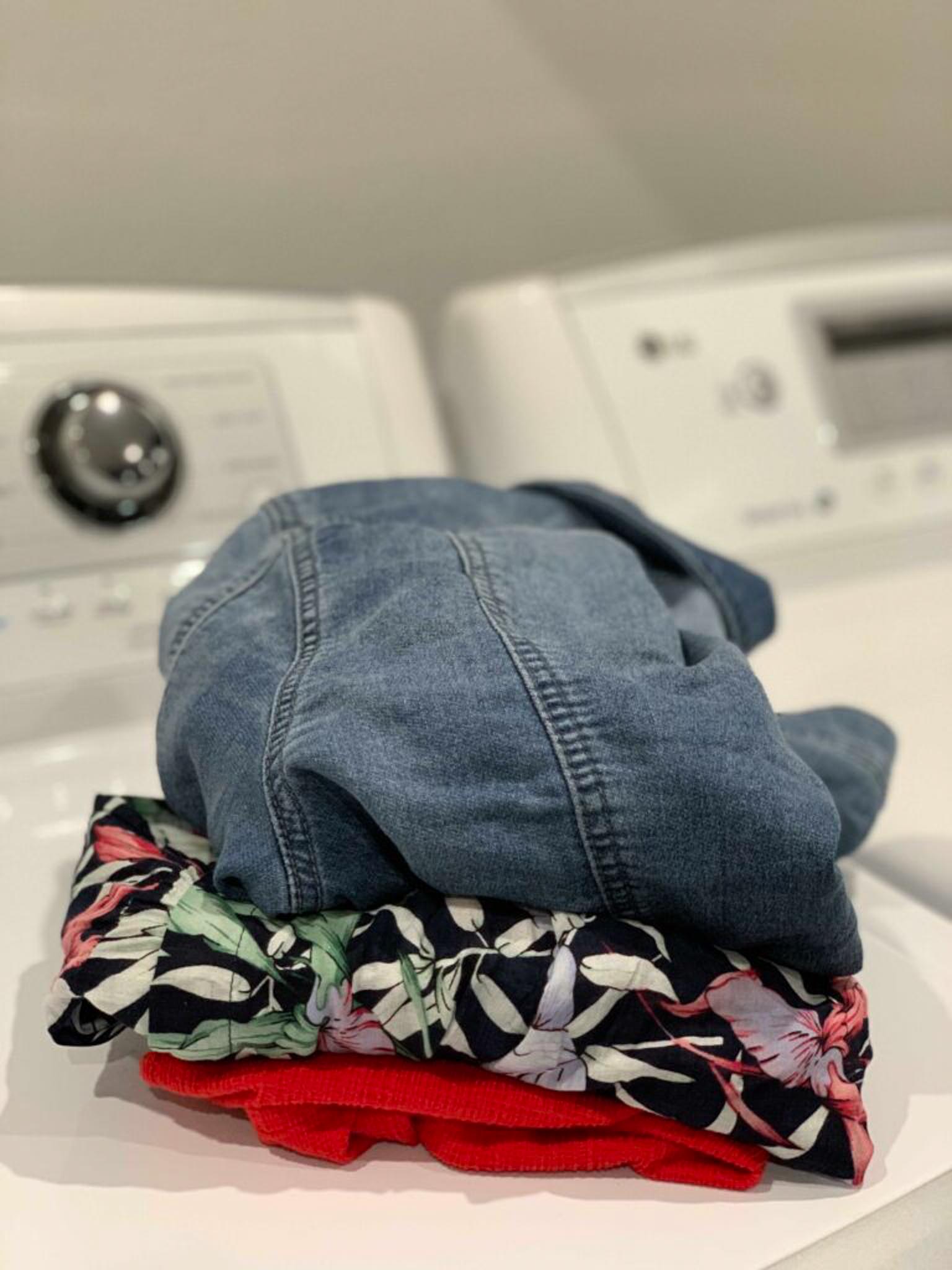 Clean clothes sitting on washing machine