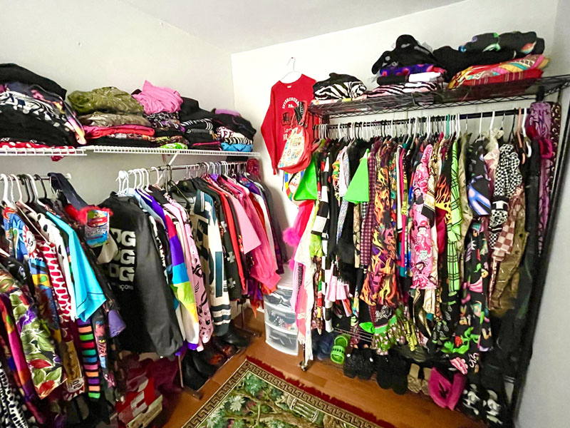 clothes and accessories folded and hung in a full, colorful closet 