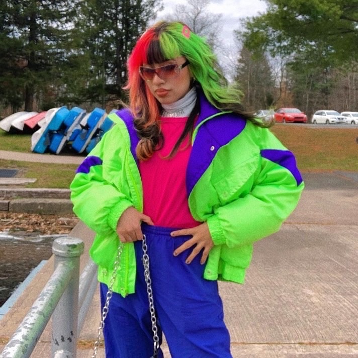 girl with neon multi colored hair wearing an 80's neon tracksuit