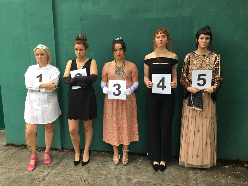 A group of people dressed as the characters from the TV show Big Little Lies wearing gowns, heels, and messy makeup.