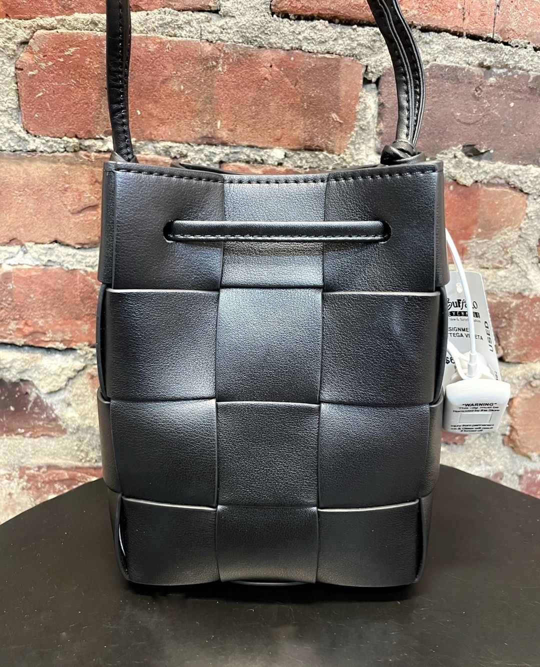 a black Bottega Veneta Bucket bag