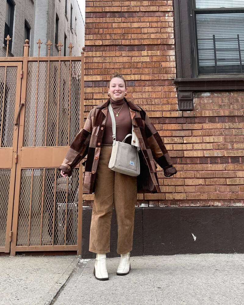 Customer @melwearswhat wearing a brown patchwork coat, brown turtleneck, brown corduroy pants, and off-white boots and tote bag.