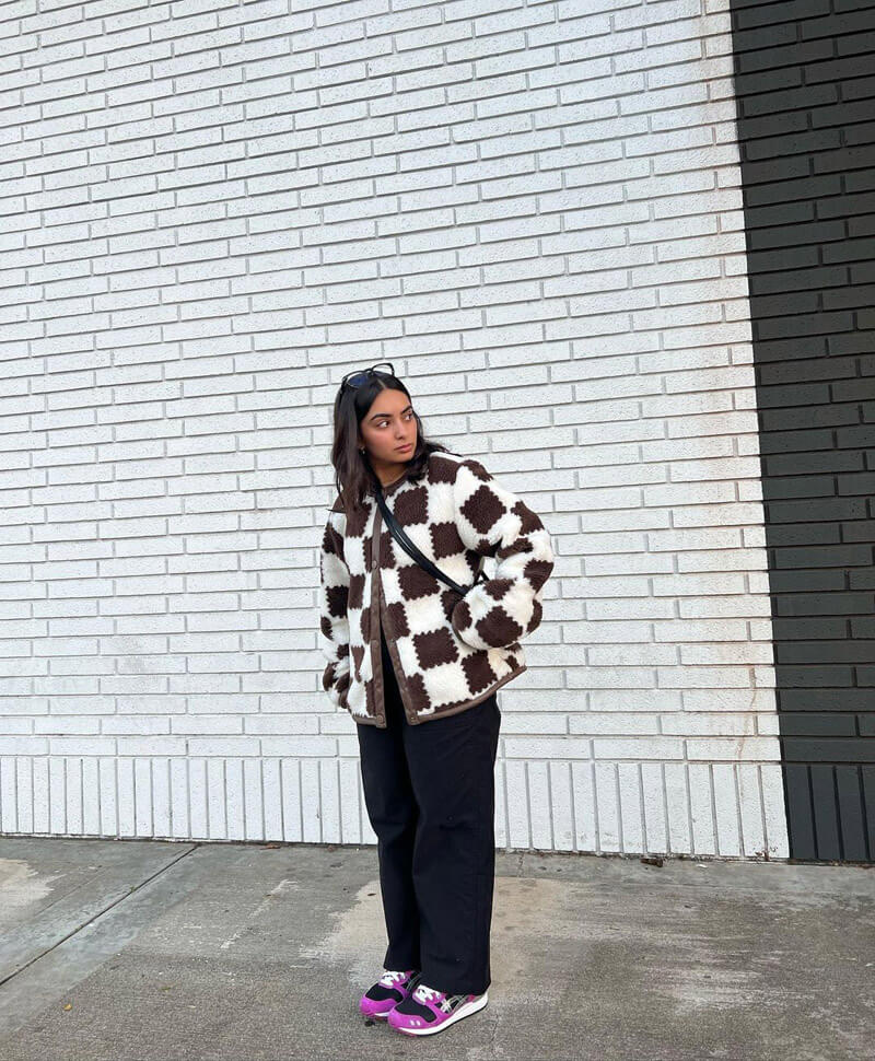 Customer @thingsimwearing wearing a brown and white checkered coat, black straight-leg pants, and fucshia sneakers