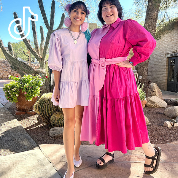 2 people wearing pink spring dresses