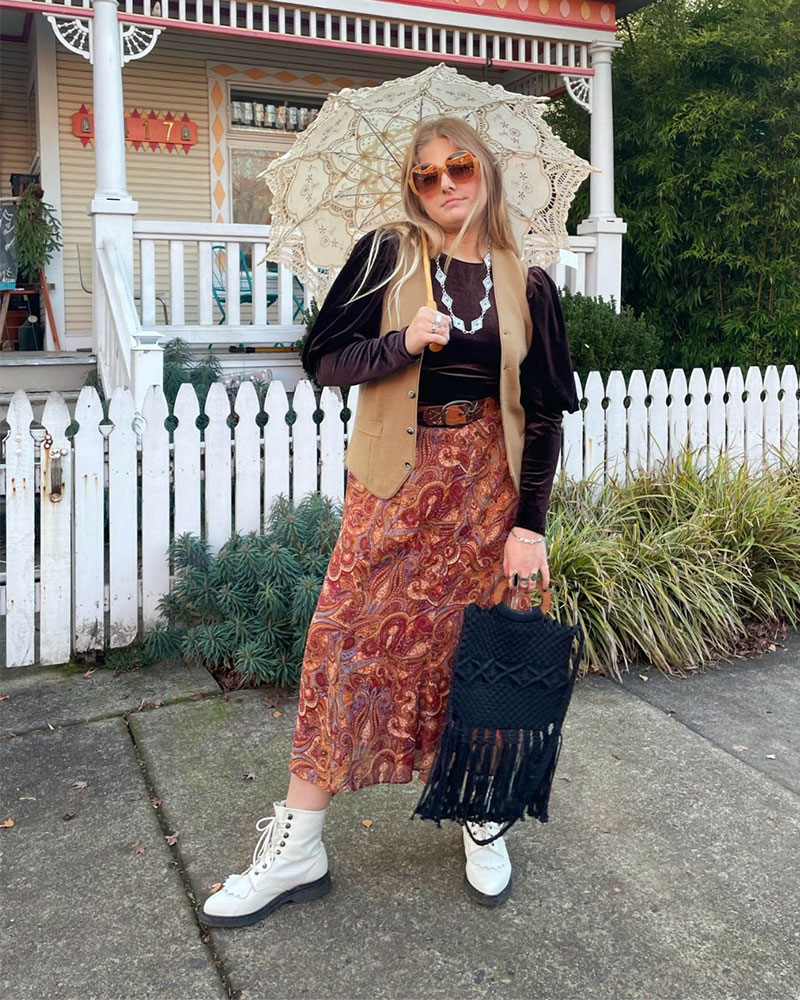 Person wearing paisley maxi skirt paired with turtleneck and suede vest