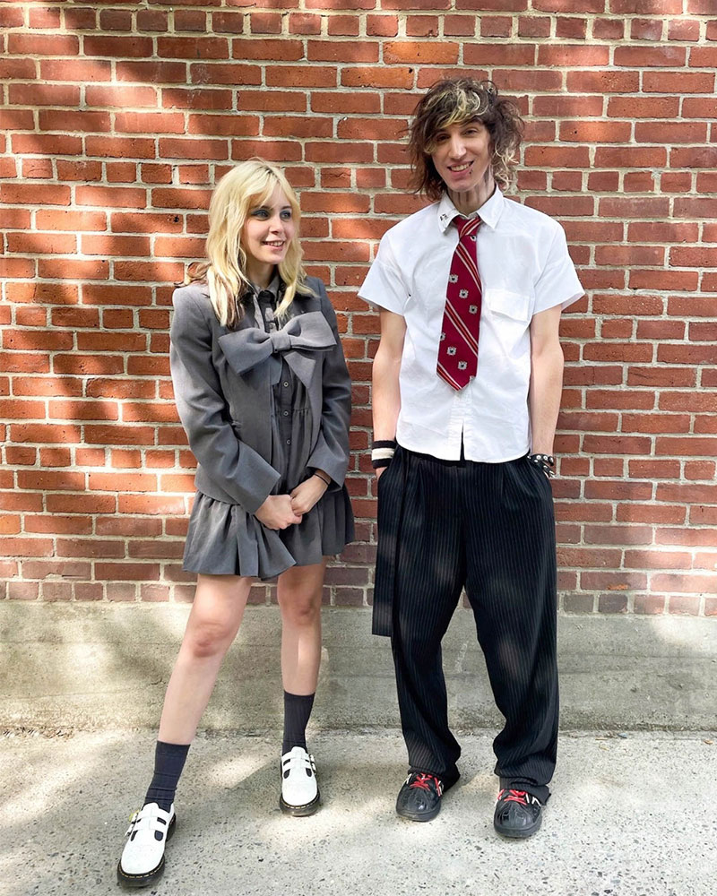 Two people wearing neckties and school uniform-inspired outfits