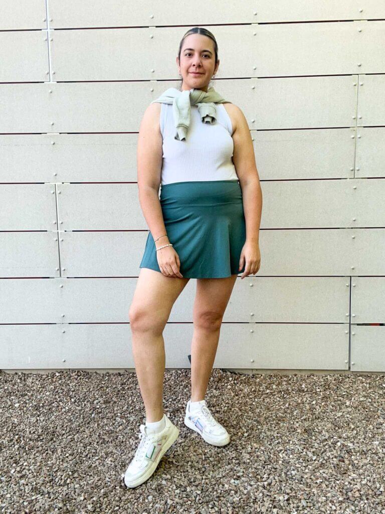 A woman dressed in tenniscore trend