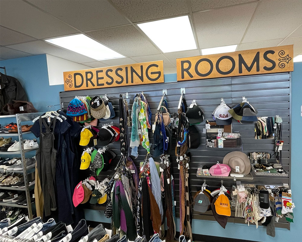 Fashion accessory wall display at Buffalo Exchange Eugene with "Dressing Rooms' sign