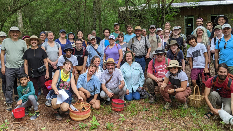 Group of people in the forest after foraging mushrooms