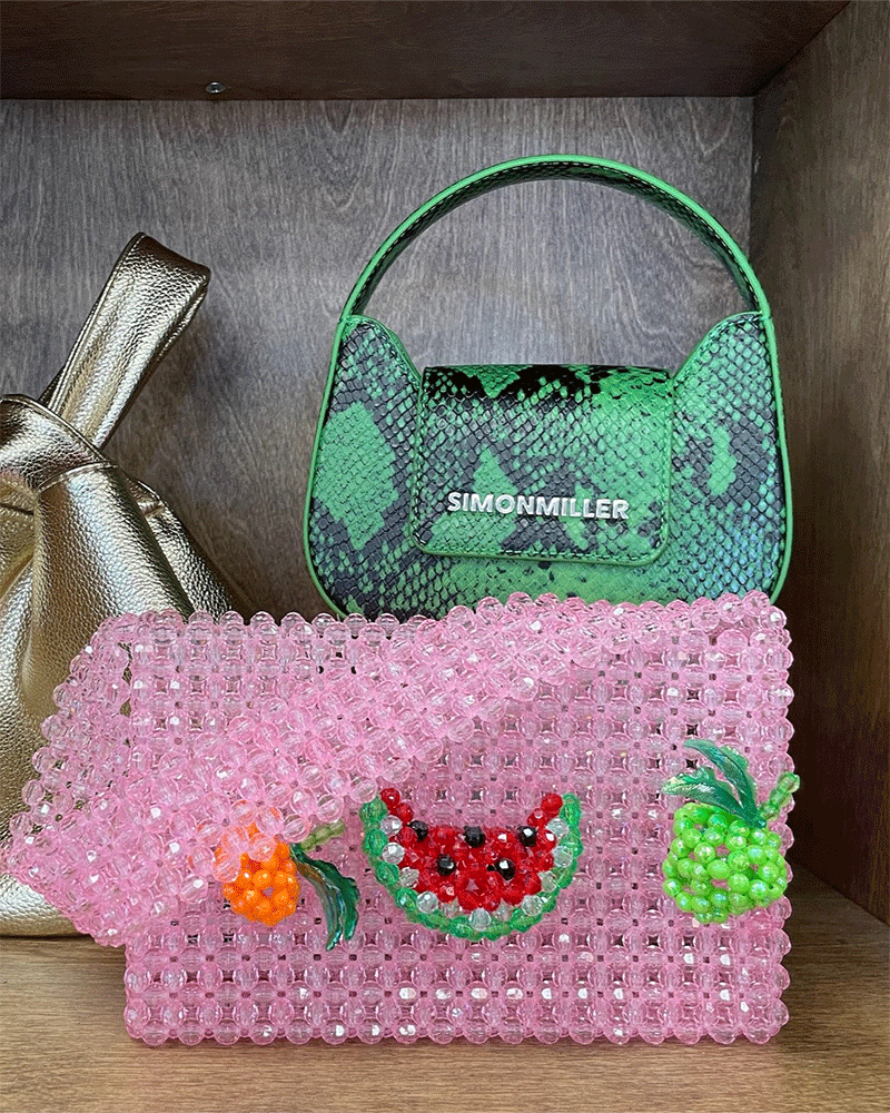 Pink beaded purse and faux snakeskin purse on shelf display