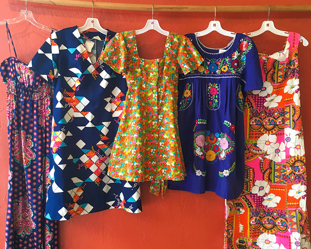 various vintage floral and southwestern dresses hanging