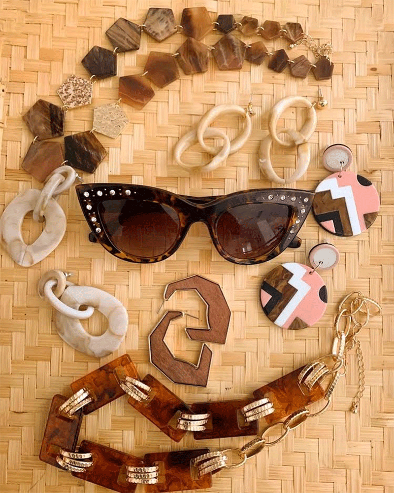 Brown sunglasses surrounded buy various vintage jewelry 