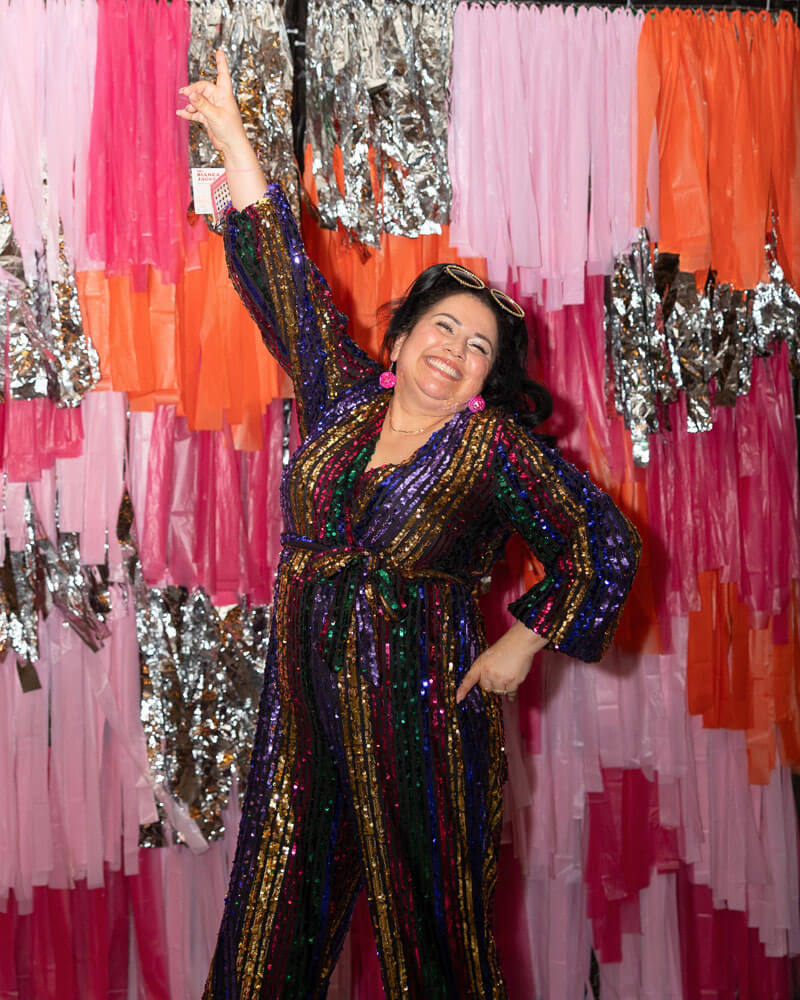 Monique in a sequined jumpsuit at Buffalo Exchange's 70s-themed 50th anniversary party