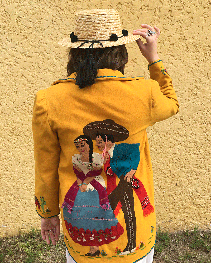 back of yellow vintage jacket with southwestern inspired embroidery