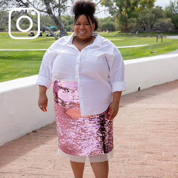 Person wearing pink sequined skirt and white button-up