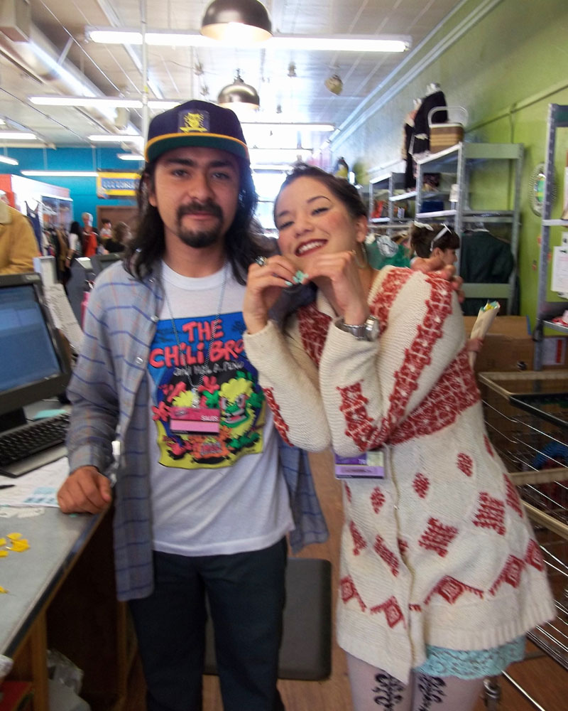 Marisa and Mikey in 2012, smiling behind the store's Buy Counter