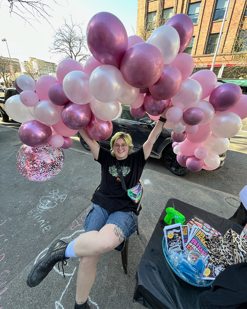 employee with pink balloons