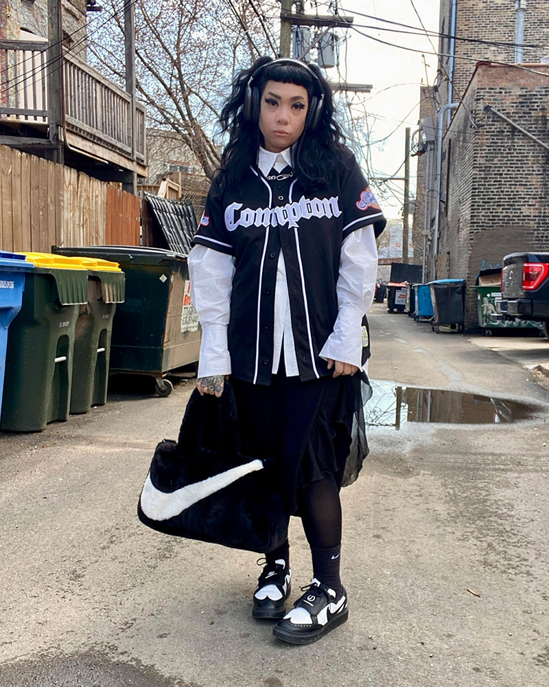 Regina in a black and white outfit showing off her streetwear style 
