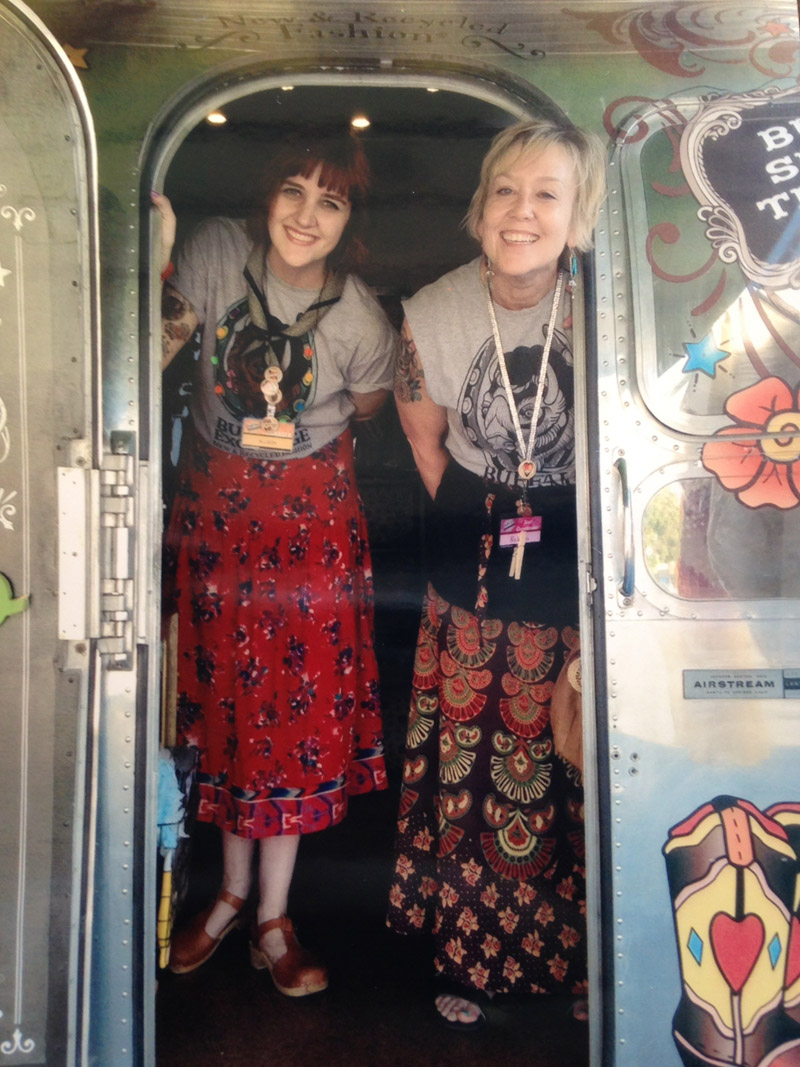 Allison and Rebecca smiling in the entrance to the Buffalo 40th Anniversary Airstream trailer