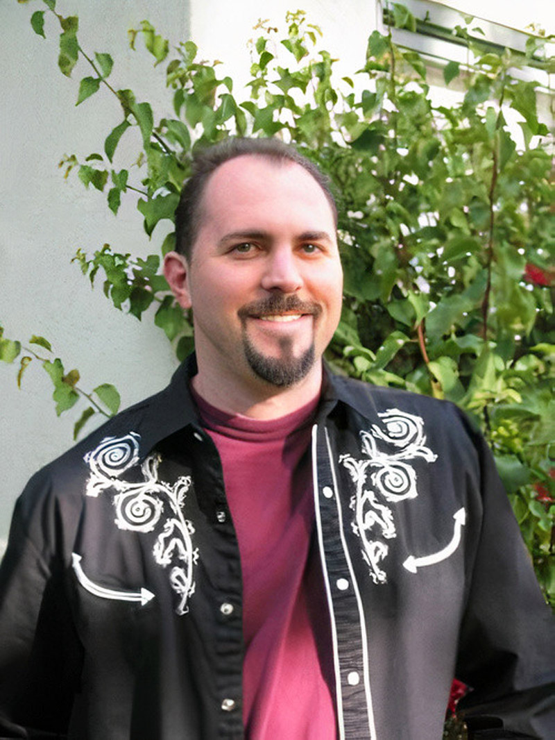 Joe in 2003, smiling in a western shirt