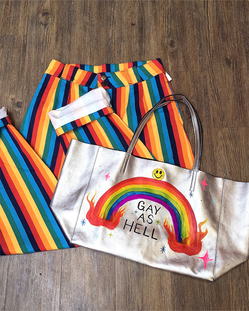Rainbow striped pants and a silver rainbow bag