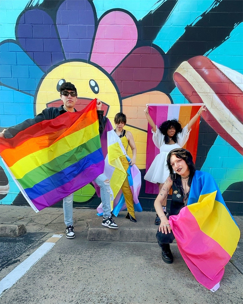 People posing with their pride flags
