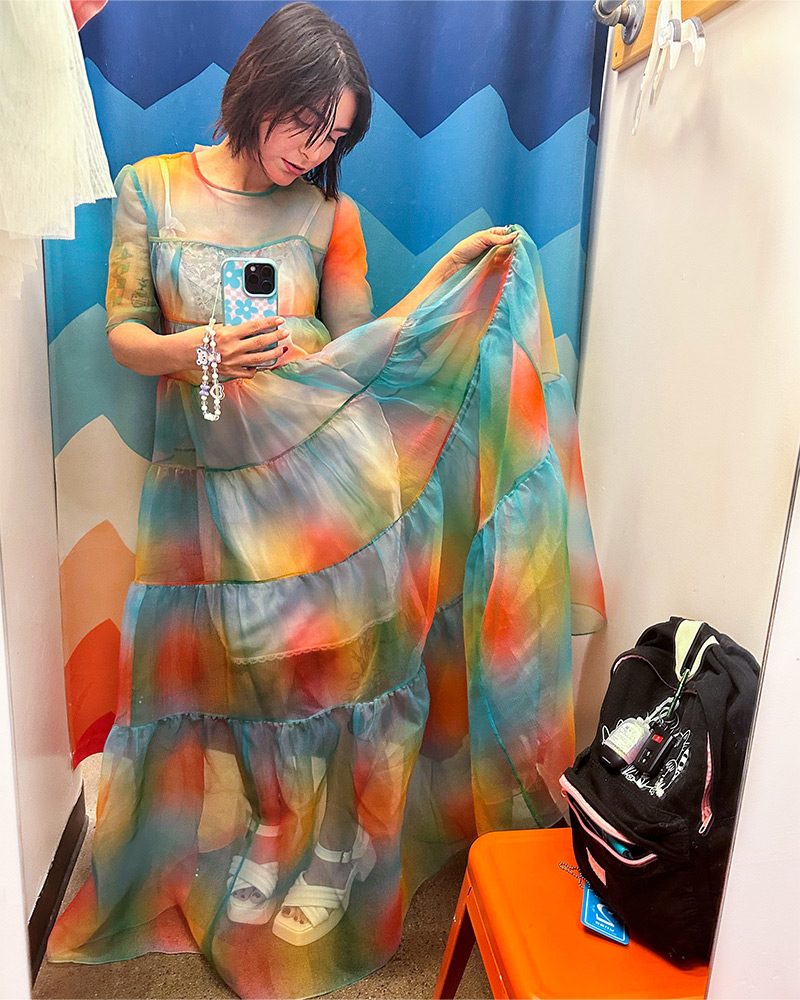 Customer trying on a rainbow sundress in the Buffalo fitting room