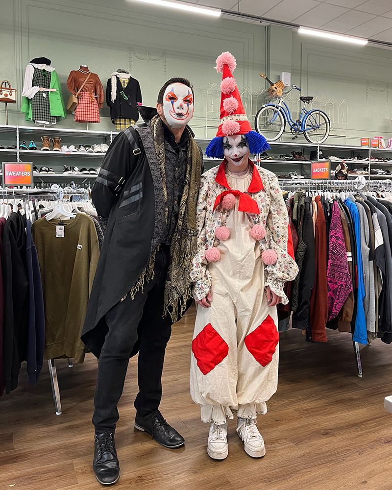 Two people in scary clown Halloween costumes