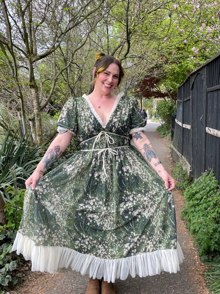 Woman wearing floral field dress by fashion designer Lirika Matoshi