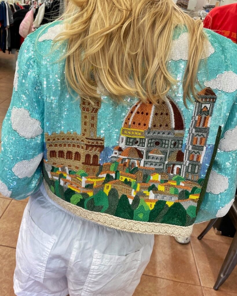 The back of a Moschino sequined jacket with an image of a church and clouds