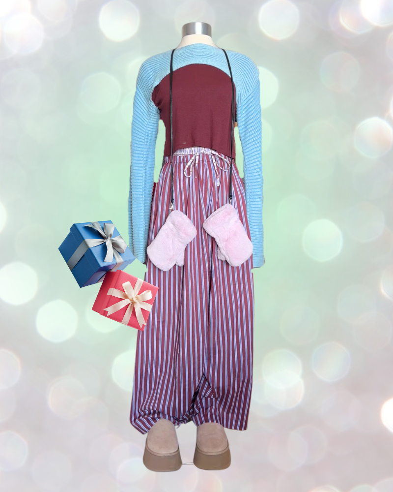 Mannequin holding wrapped gifts wears striped pajama pants, Ugg boots, red t-shirt and cropped blue sweater