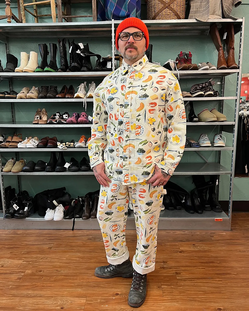 Employee in colorful suit covered in pictures of food