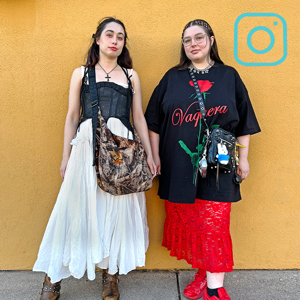 2 people standing in front of yellow wall wearing skirts