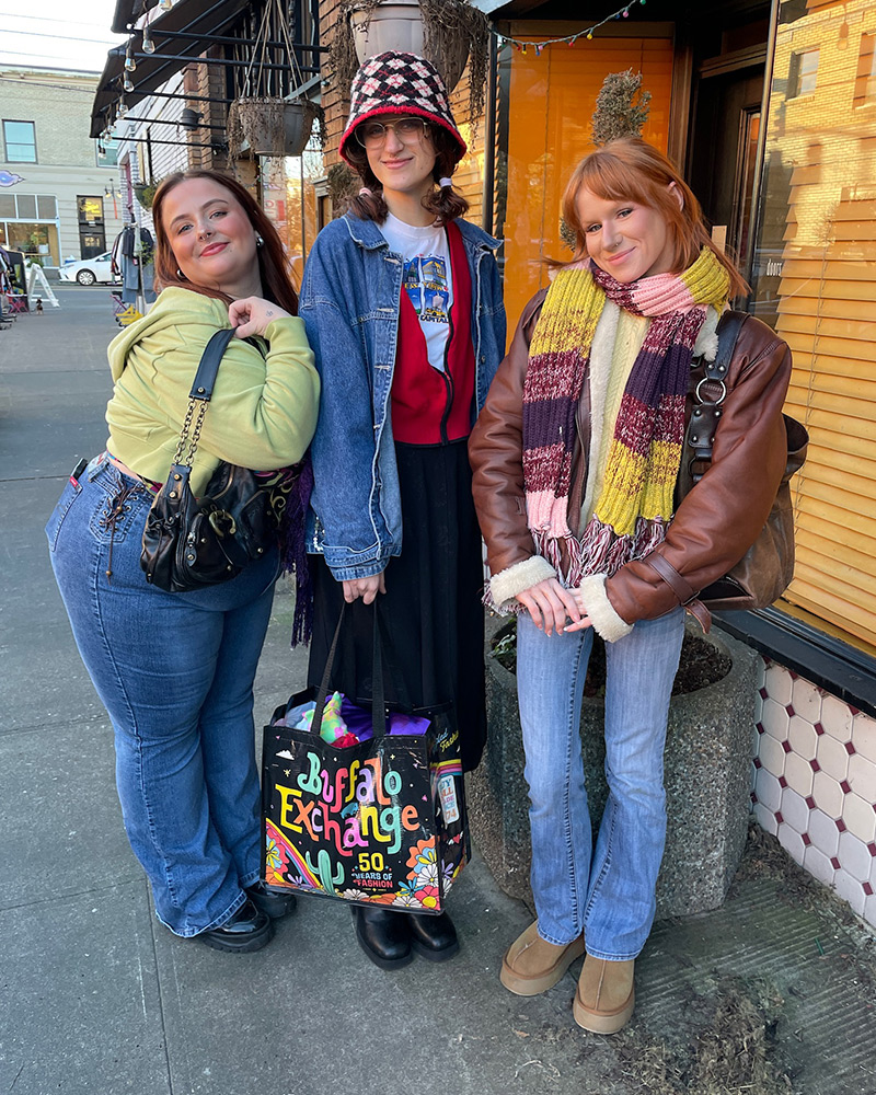 Three friends posing for the camera with Buffalo tote bag