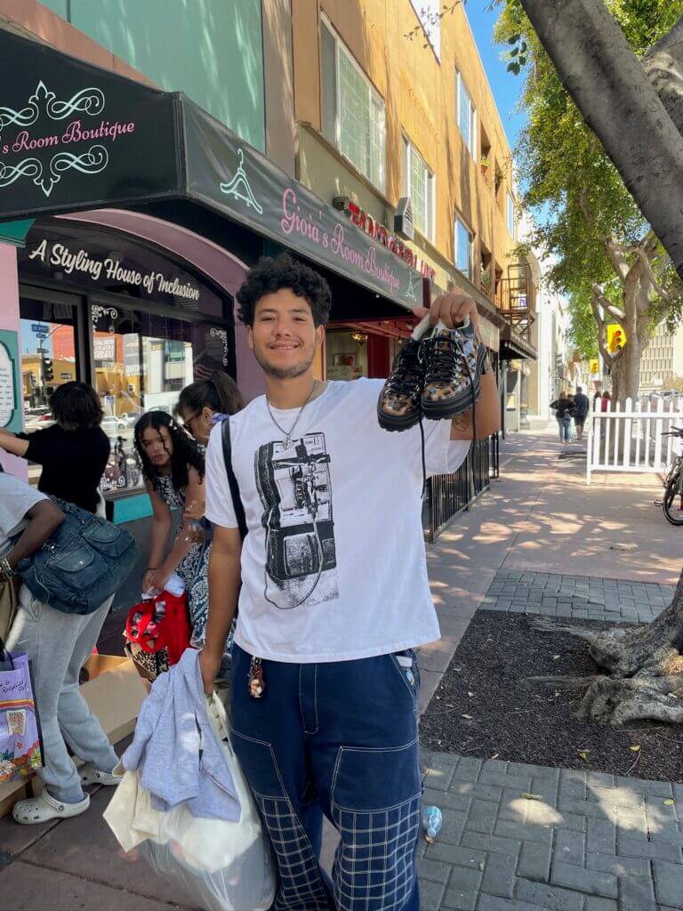 shopper holding shoes up for earth day
