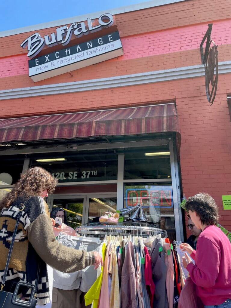 shoppers outside looking through rack